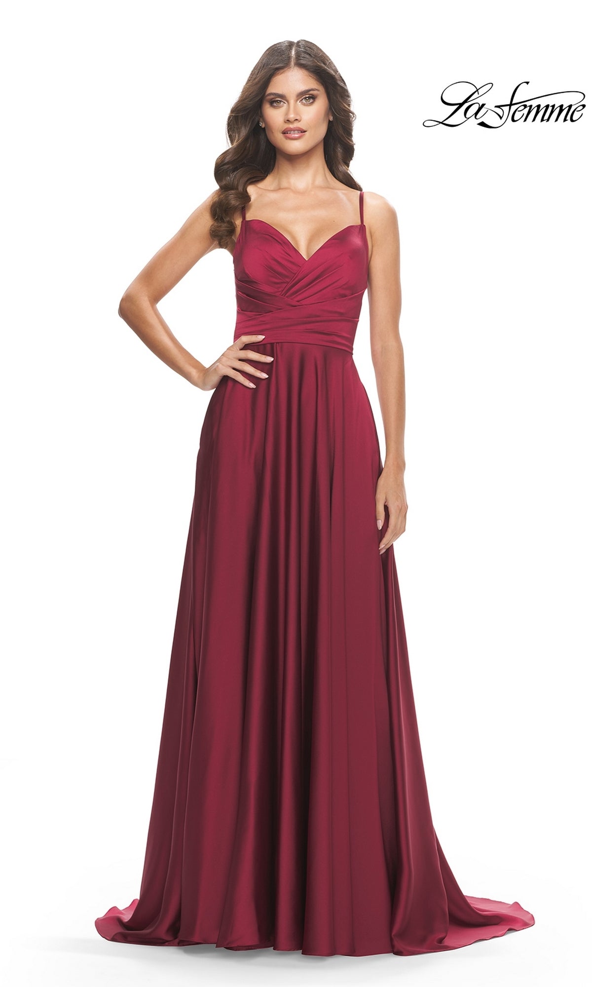 A woman models the La Femme Open-Back A-Line Designer Prom Dress 31233, featuring a sleeveless, floor-length silhouette and fitted bodice with flowing skirt, posing against a white background with the logo in the top right corner.